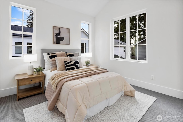 bedroom featuring lofted ceiling, carpet flooring, and baseboards