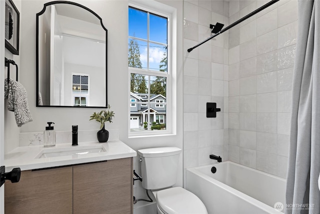 full bath featuring toilet, shower / tub combo with curtain, and vanity