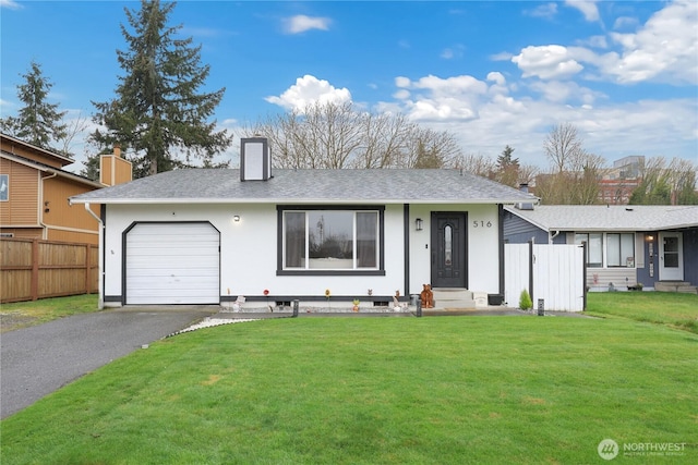 view of front of home featuring aphalt driveway, a chimney, an attached garage, a front yard, and fence