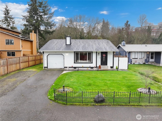 view of front of property with a shingled roof, aphalt driveway, an attached garage, fence private yard, and a front yard