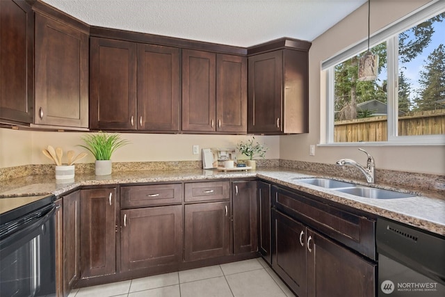 kitchen with light tile patterned floors, dark brown cabinetry, a sink, light stone countertops, and black appliances