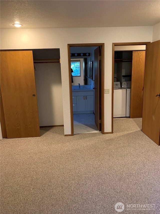 304 10th St, Kirkland, WA 98033 - unfurnished bedroom with a sink, washing machine and clothes dryer, connected bathroom, a textured ceiling, and carpet floors
