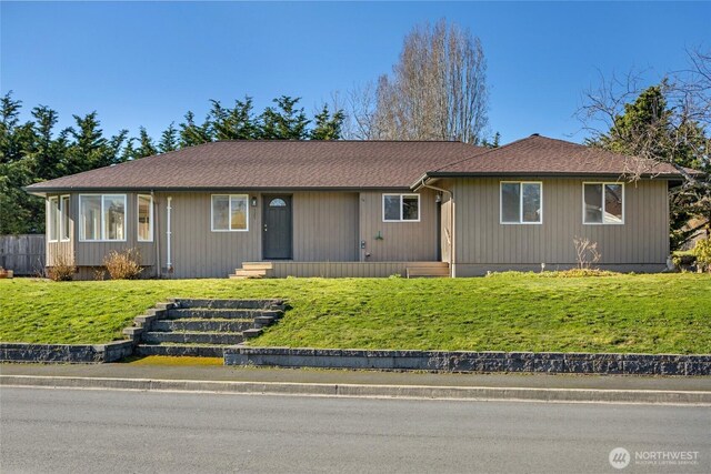 single story home with a front lawn and roof with shingles