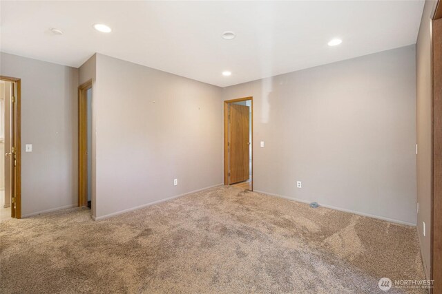 carpeted empty room featuring recessed lighting and baseboards