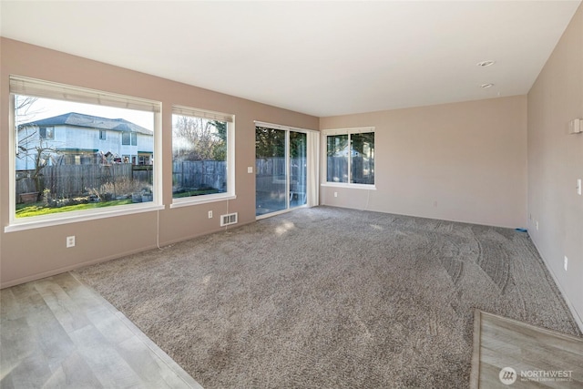 spare room with carpet and visible vents