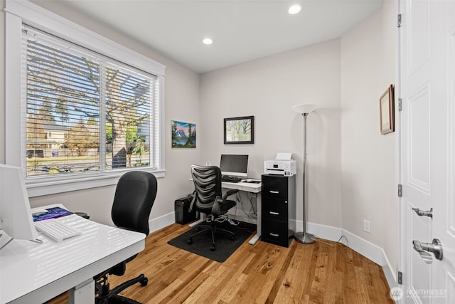 office featuring light wood-style floors, baseboards, and recessed lighting