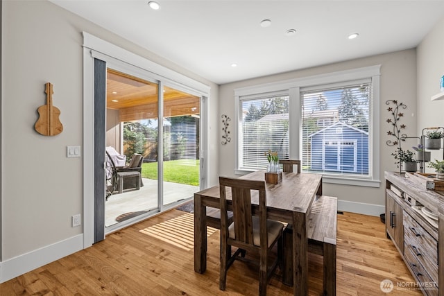 dining room featuring baseboards, recessed lighting, and light wood-style floors