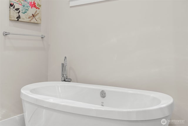 bathroom with a freestanding tub