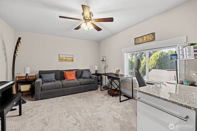 living area featuring light carpet, ceiling fan, and baseboards