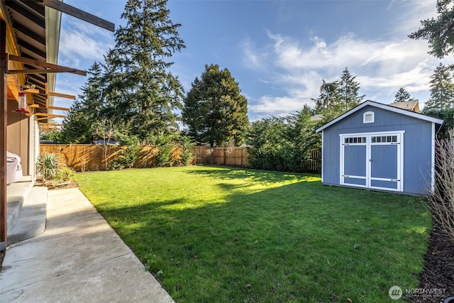 view of yard with a fenced backyard, an outdoor structure, and a storage shed