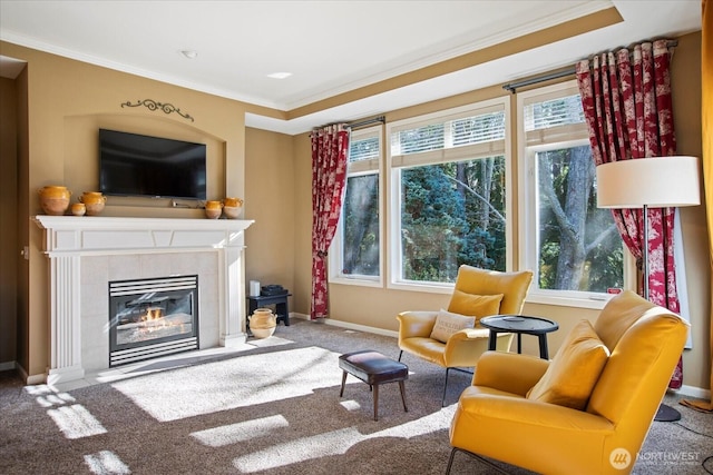 living area featuring crown molding, carpet floors, a fireplace, and a healthy amount of sunlight