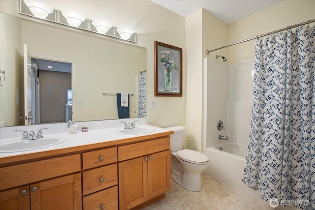 bathroom featuring toilet, double vanity, a sink, and shower / tub combo with curtain