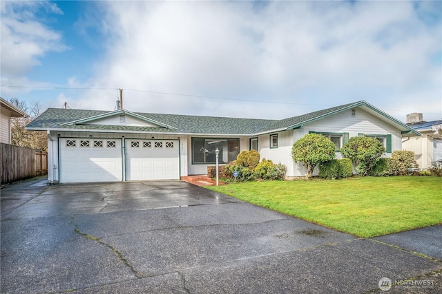 single story home with aphalt driveway, roof with shingles, an attached garage, a front yard, and fence