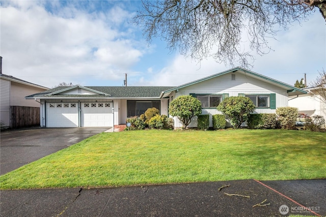 single story home with a garage, driveway, and a front lawn