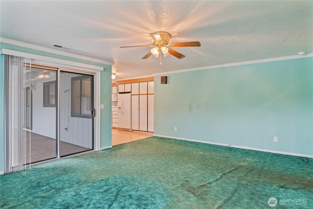 carpeted spare room featuring baseboards, a textured ceiling, visible vents, and crown molding