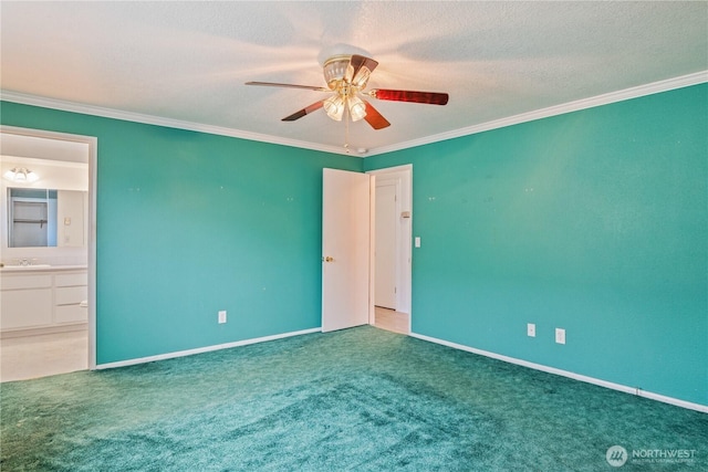 empty room featuring baseboards, a ceiling fan, a textured ceiling, crown molding, and carpet floors