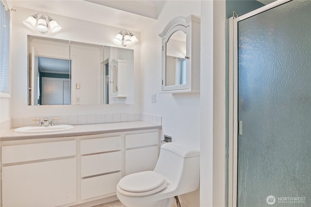 full bath with a stall shower, vanity, and toilet