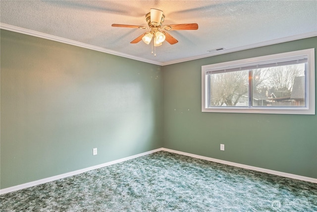 empty room with carpet, baseboards, and a textured ceiling