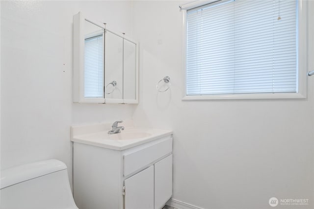 bathroom with toilet and vanity