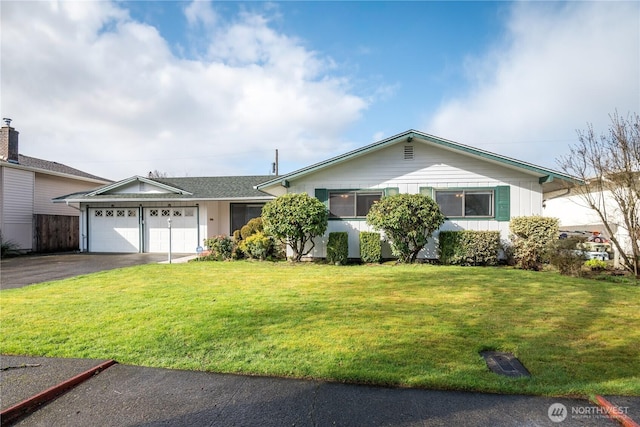 ranch-style home featuring a garage, a front yard, and driveway