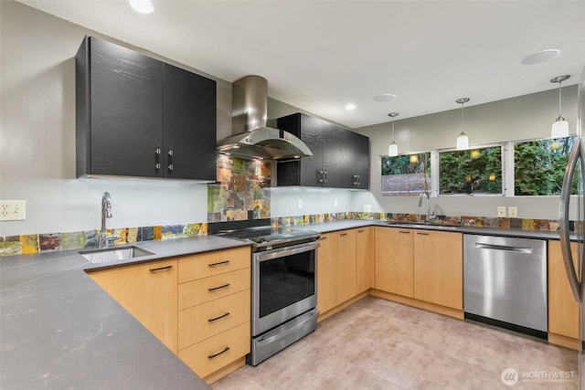 kitchen with wall chimney exhaust hood, light brown cabinets, appliances with stainless steel finishes, and a sink