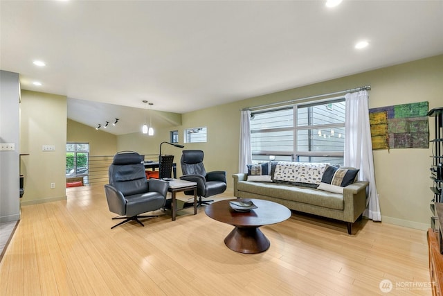 living area with lofted ceiling, light wood-style flooring, recessed lighting, and baseboards