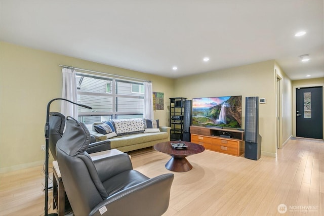 living room featuring light wood-style flooring, recessed lighting, and baseboards