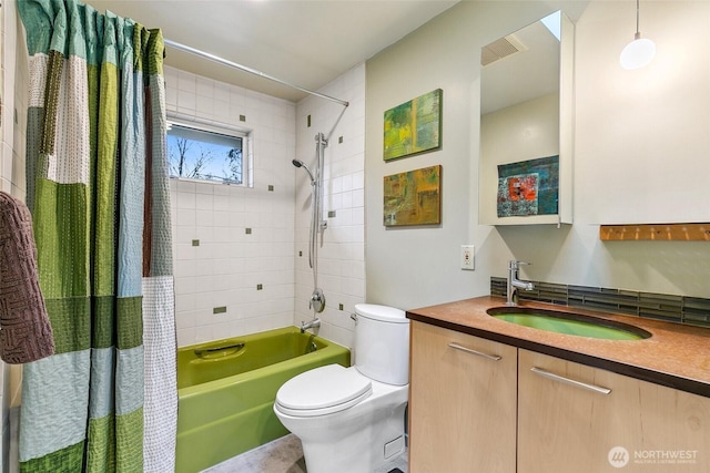 bathroom with vanity, toilet, visible vents, and shower / tub combo with curtain