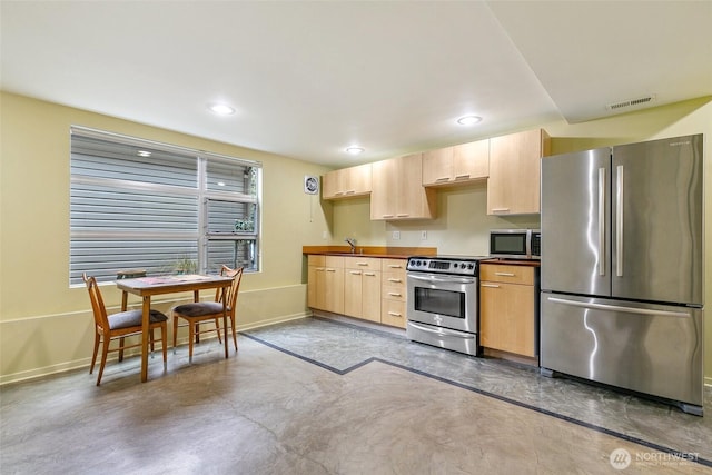 kitchen featuring a sink, stainless steel appliances, visible vents, and light brown cabinets