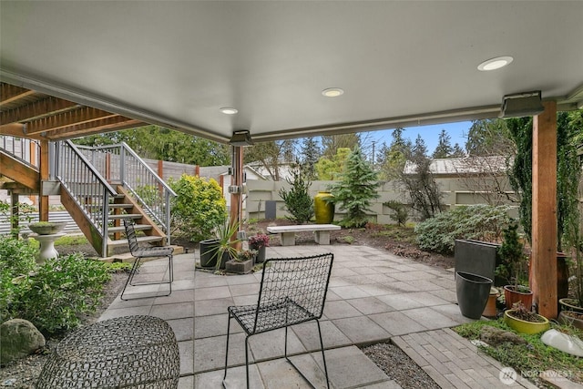 view of patio / terrace featuring stairs and a fenced backyard