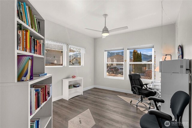 office area featuring wood finished floors, a ceiling fan, and baseboards