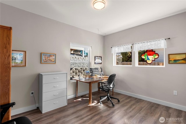 office space with baseboards and wood finished floors