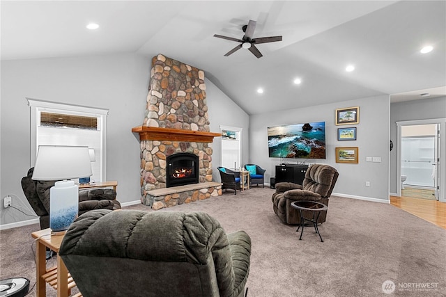 living room featuring carpet floors, a fireplace, baseboards, and a ceiling fan