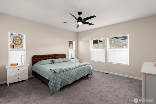 bedroom with ceiling fan, dark colored carpet, and baseboards