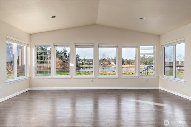 unfurnished sunroom featuring vaulted ceiling