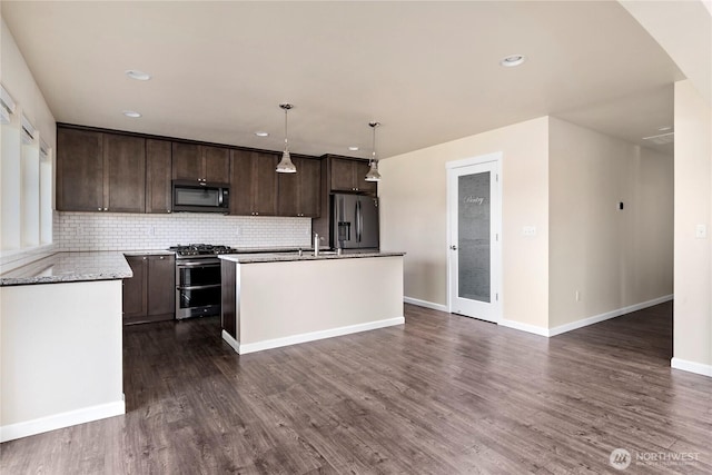 kitchen featuring dark brown cabinetry, dark wood-type flooring, stainless steel appliances, and decorative backsplash