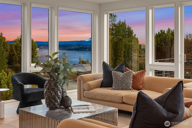 sunroom / solarium featuring a water view