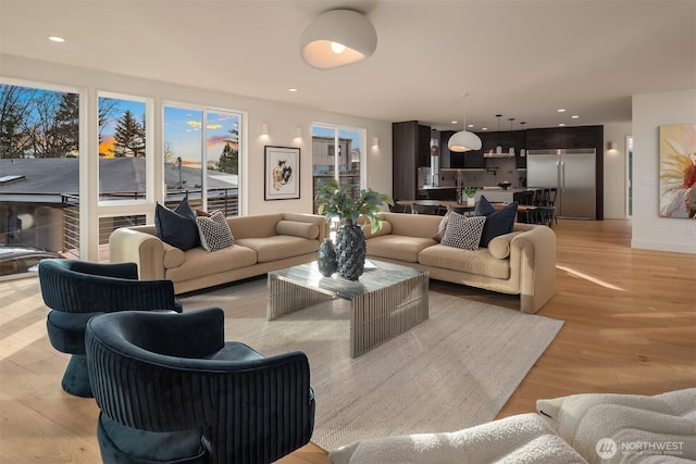 living room featuring light wood-style flooring and recessed lighting