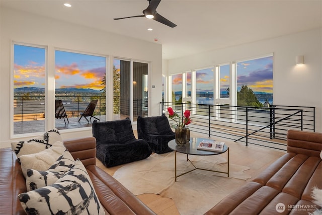 living area featuring a healthy amount of sunlight, ceiling fan, wood finished floors, and recessed lighting