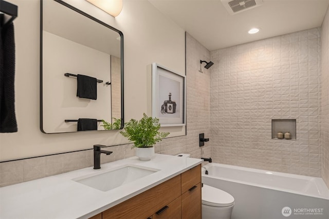 full bathroom with shower / bath combination, visible vents, vanity, and toilet