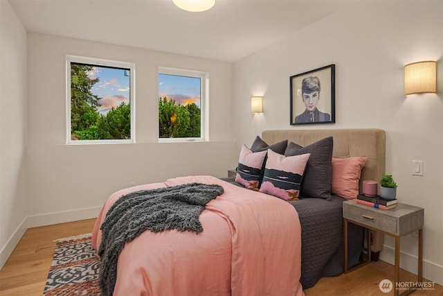 bedroom featuring light wood-type flooring and baseboards