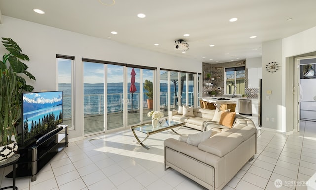 living area featuring light tile patterned floors and recessed lighting