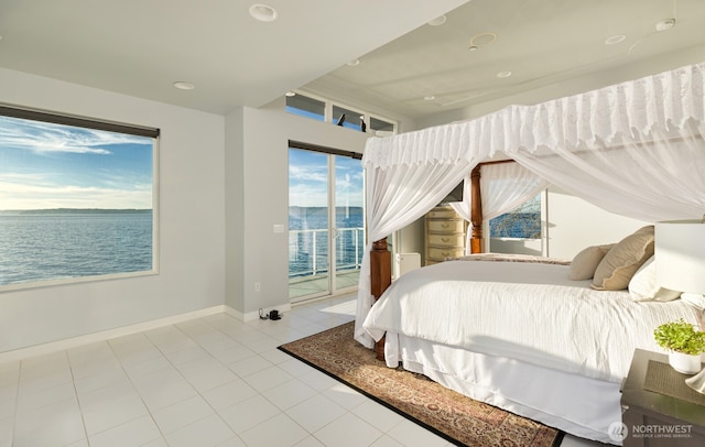 tiled bedroom with access to outside, a water view, and baseboards