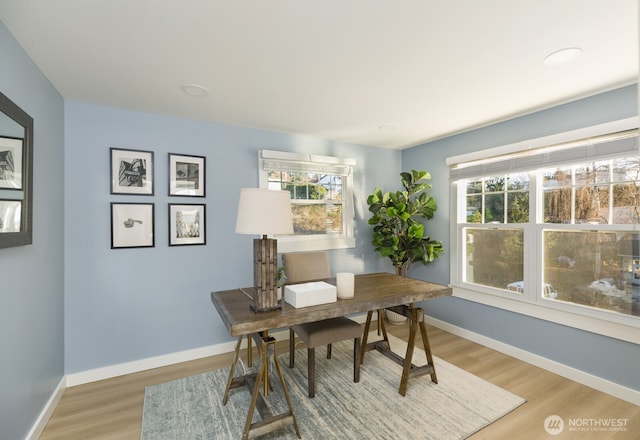 home office featuring baseboards and wood finished floors