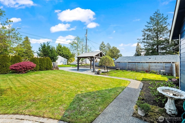 view of yard with a fenced backyard, a gazebo, and a patio