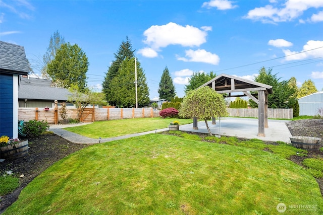 view of yard featuring a patio area, a fenced backyard, and a gazebo
