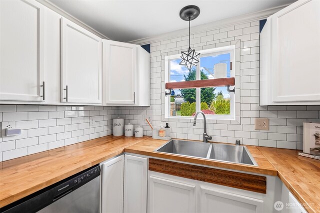 kitchen featuring wooden counters, dishwasher, a sink, decorative backsplash, and white cabinetry