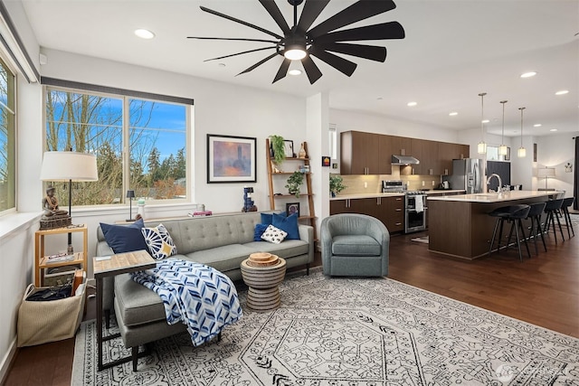 living area featuring dark wood-style floors and recessed lighting