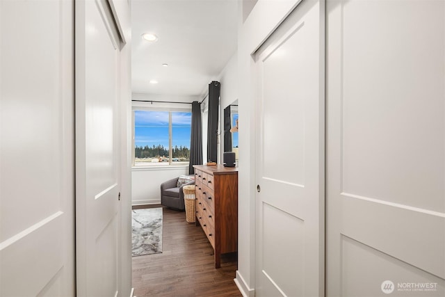 corridor with dark wood-style floors and recessed lighting