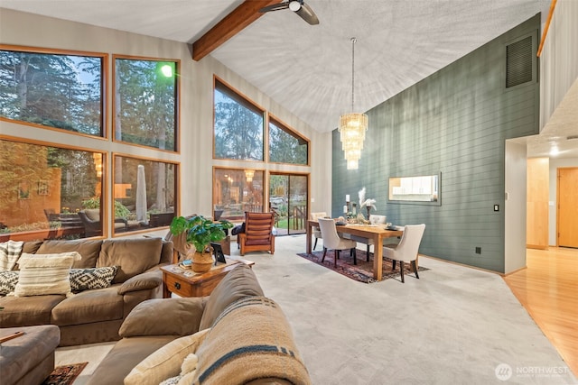 sunroom with beamed ceiling, visible vents, and a notable chandelier